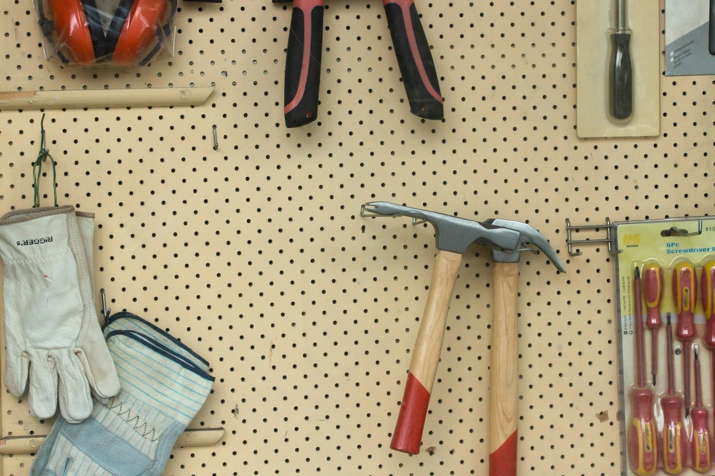 Hand tools neatly organized on a workshop pegboard.